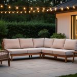 Modular outdoor patio seating with plush cushions, woven wicker accents, and warm string lights creating an indoor-style outdoor living room.